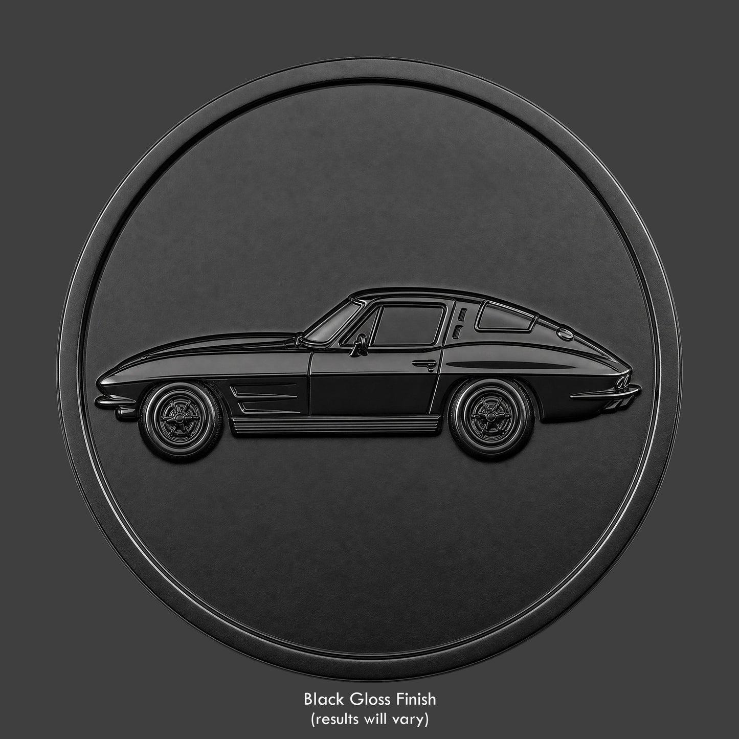 A black finished, resin sculpted coin of a '63 split window Corvette