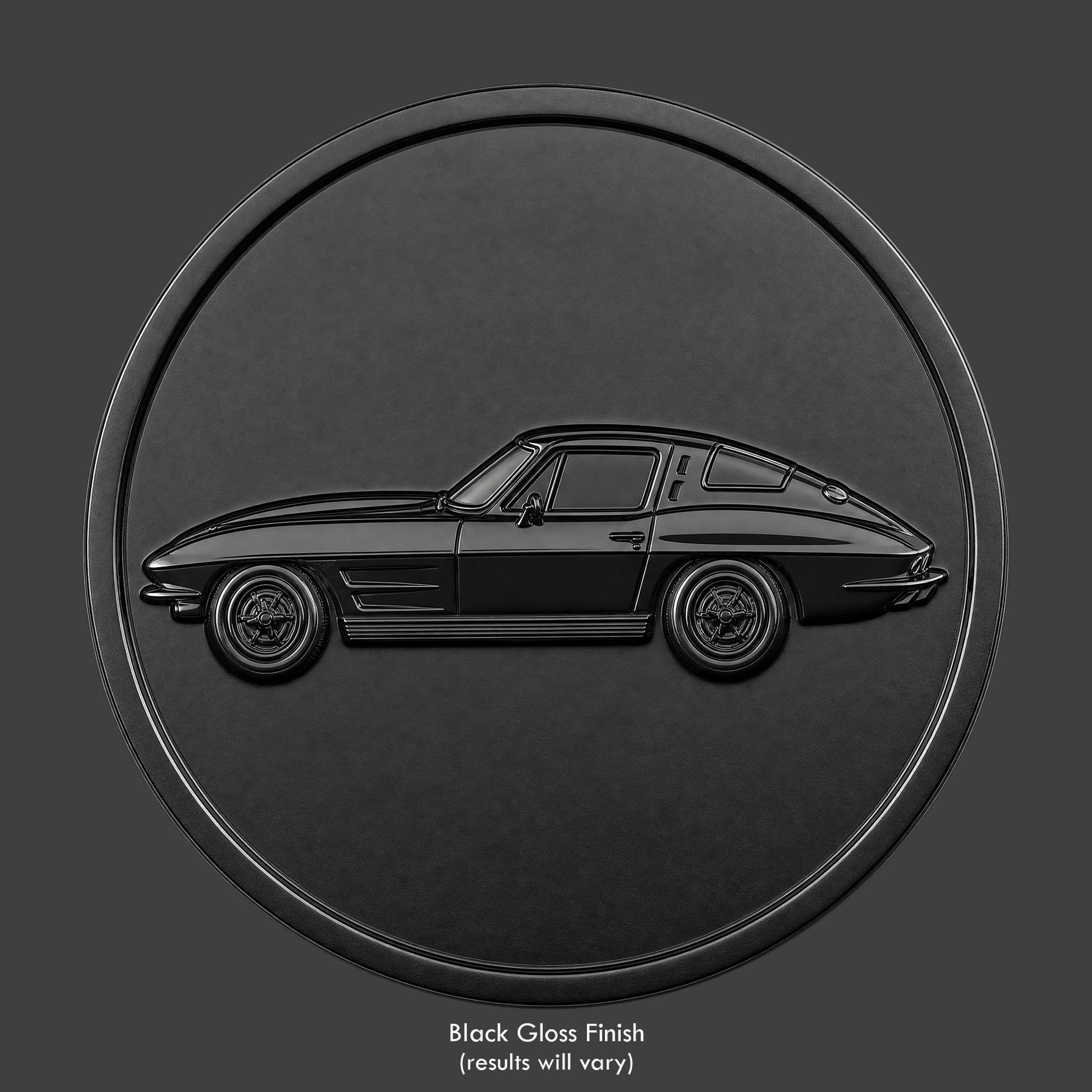 A black finished, resin sculpted coin of a '63 split window Corvette