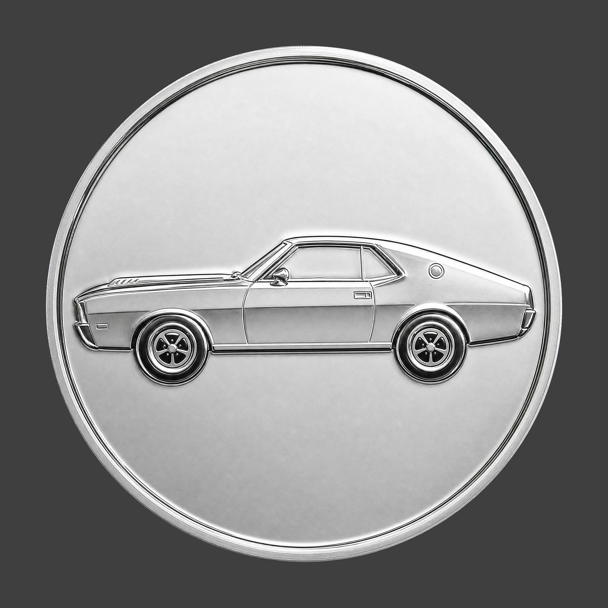 A silver finished, resin sculpted coin of a AMC AMX car