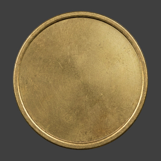A brass distressed blank coin