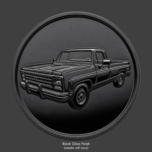 A brass finished, resin sculpted coin of a square body truck