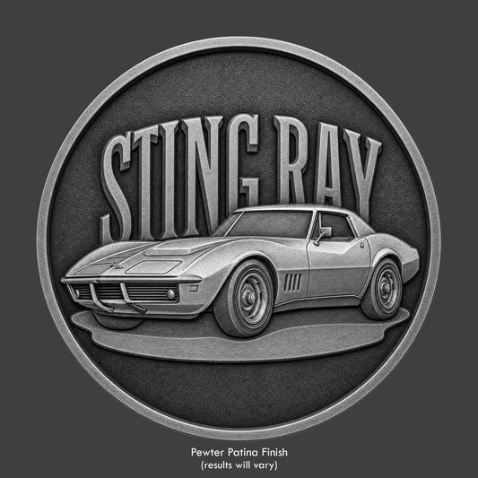 A pewter finished, resin sculpted coin of a Corvette Stingray