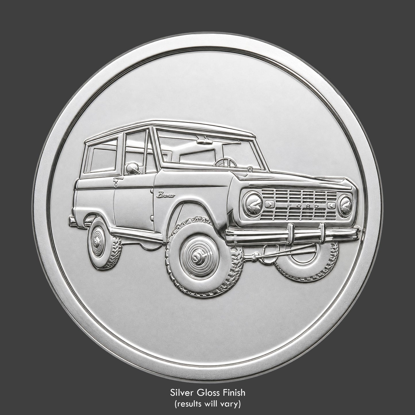 A silver finished, resin sculpted coin of a Ford Bronco