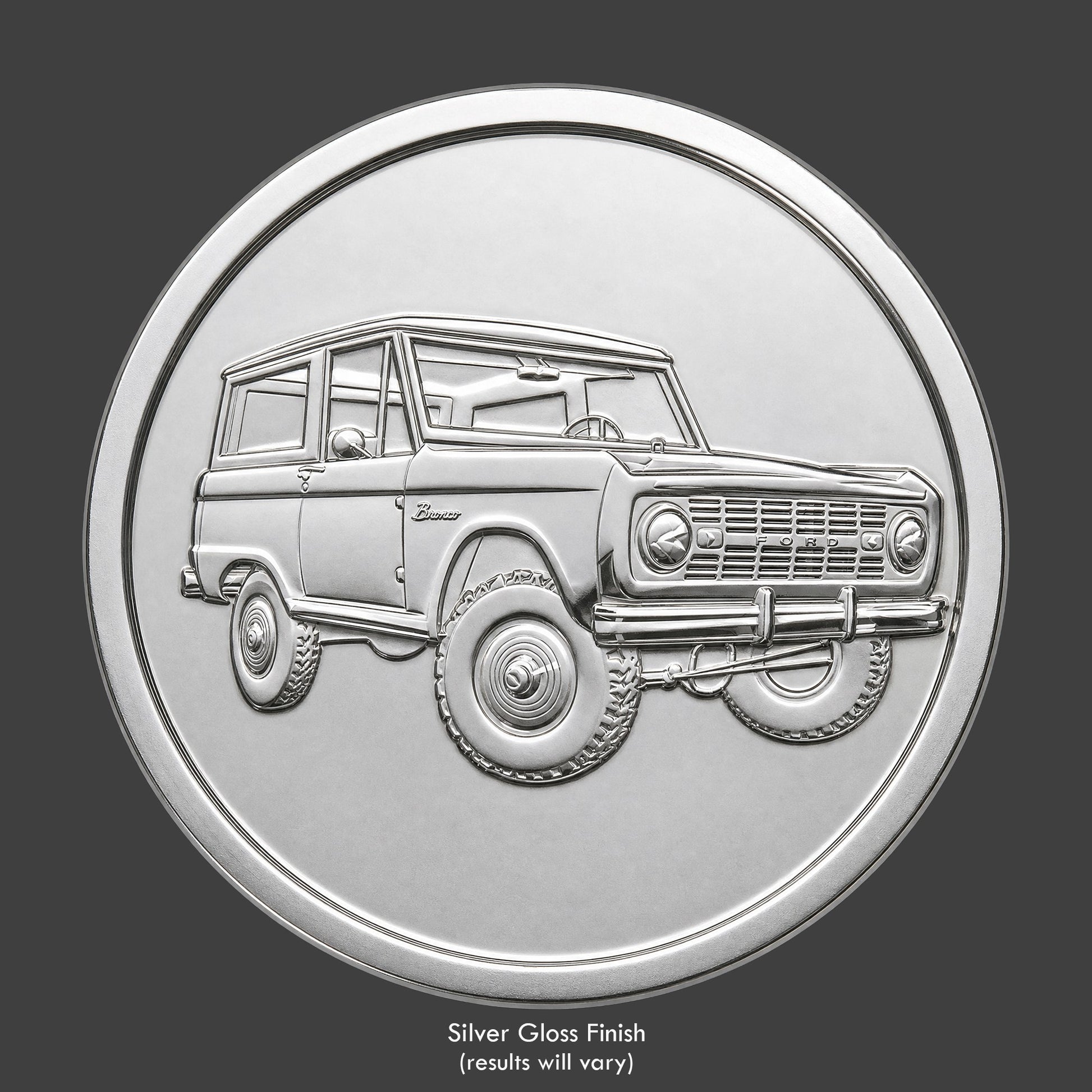 A silver finished, resin sculpted coin of a Ford Bronco