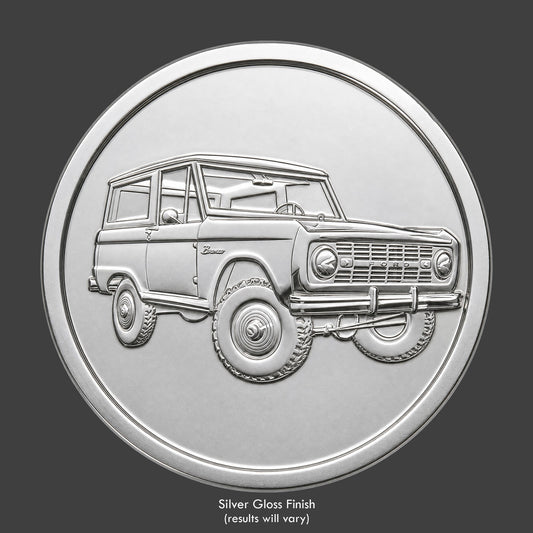 A silver finished, resin sculpted coin of a Ford Bronco