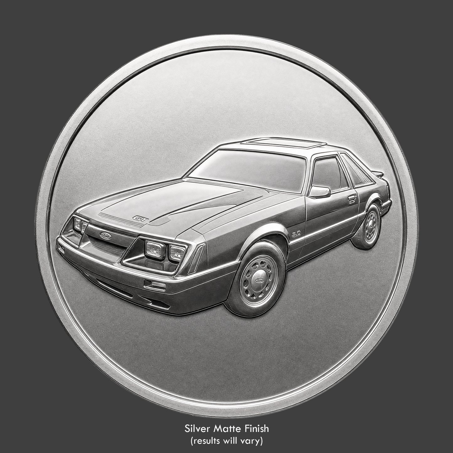 A silver finished, resin sculpted coin of a Ford Mustango GT