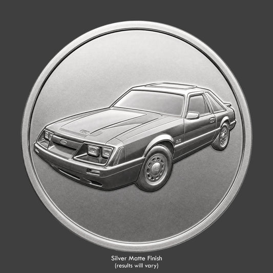 A silver finished, resin sculpted coin of a Ford Mustango GT
