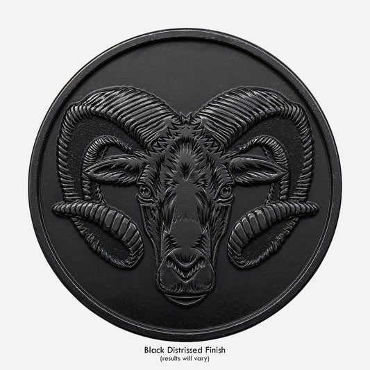 A ram on a distressed black coin