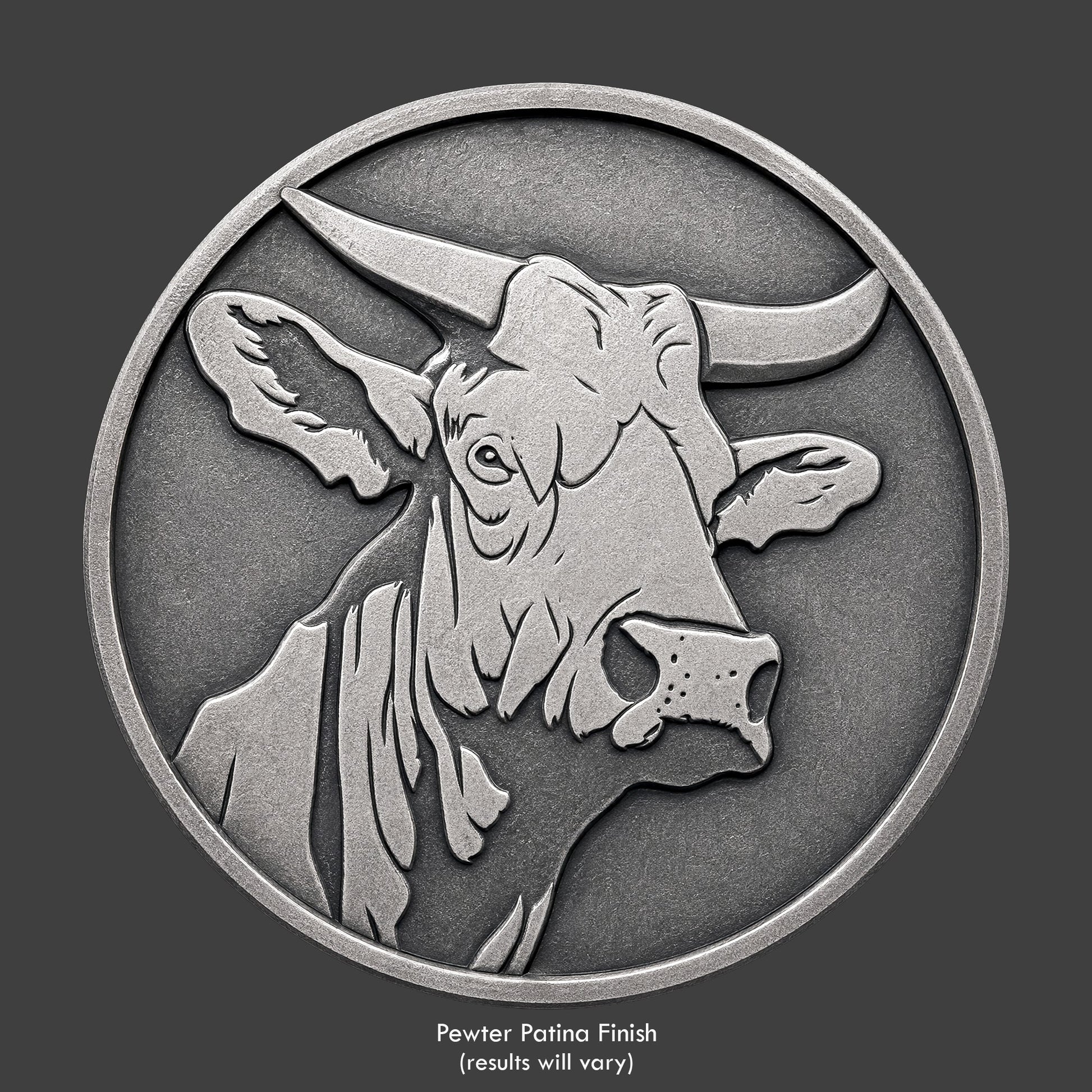 A pewter finished, resin sculpted coin of a bull