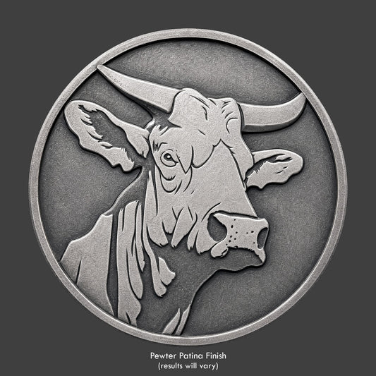 A pewter finished, resin sculpted coin of a bull