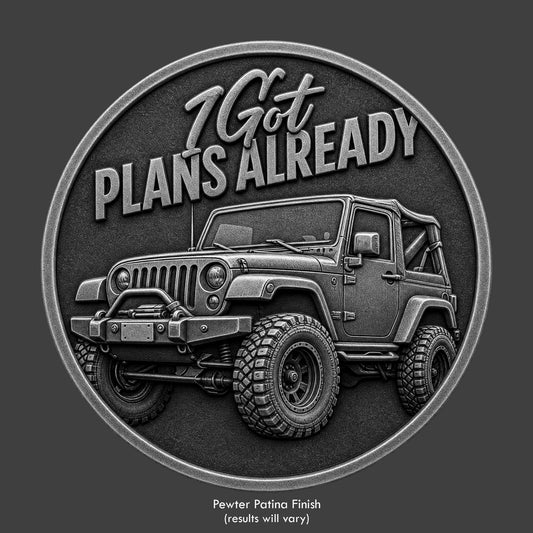 A pewter finished, resin sculpted coin of a Jeep