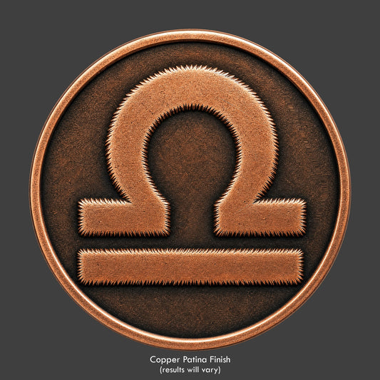 A Libra Zodiac symbol on a copper patina coin