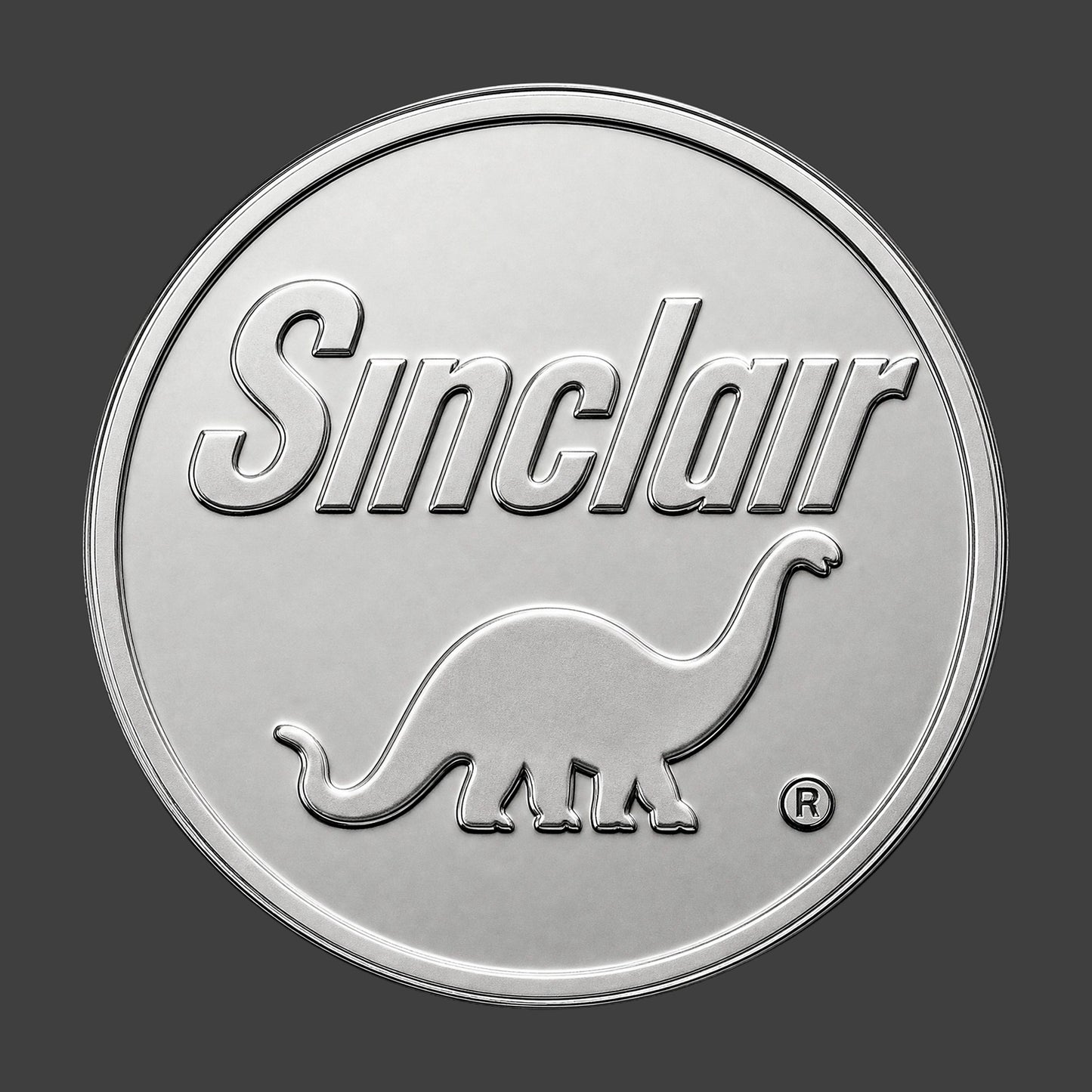 A silver finished, resin sculpted coin of a Sinclair logo