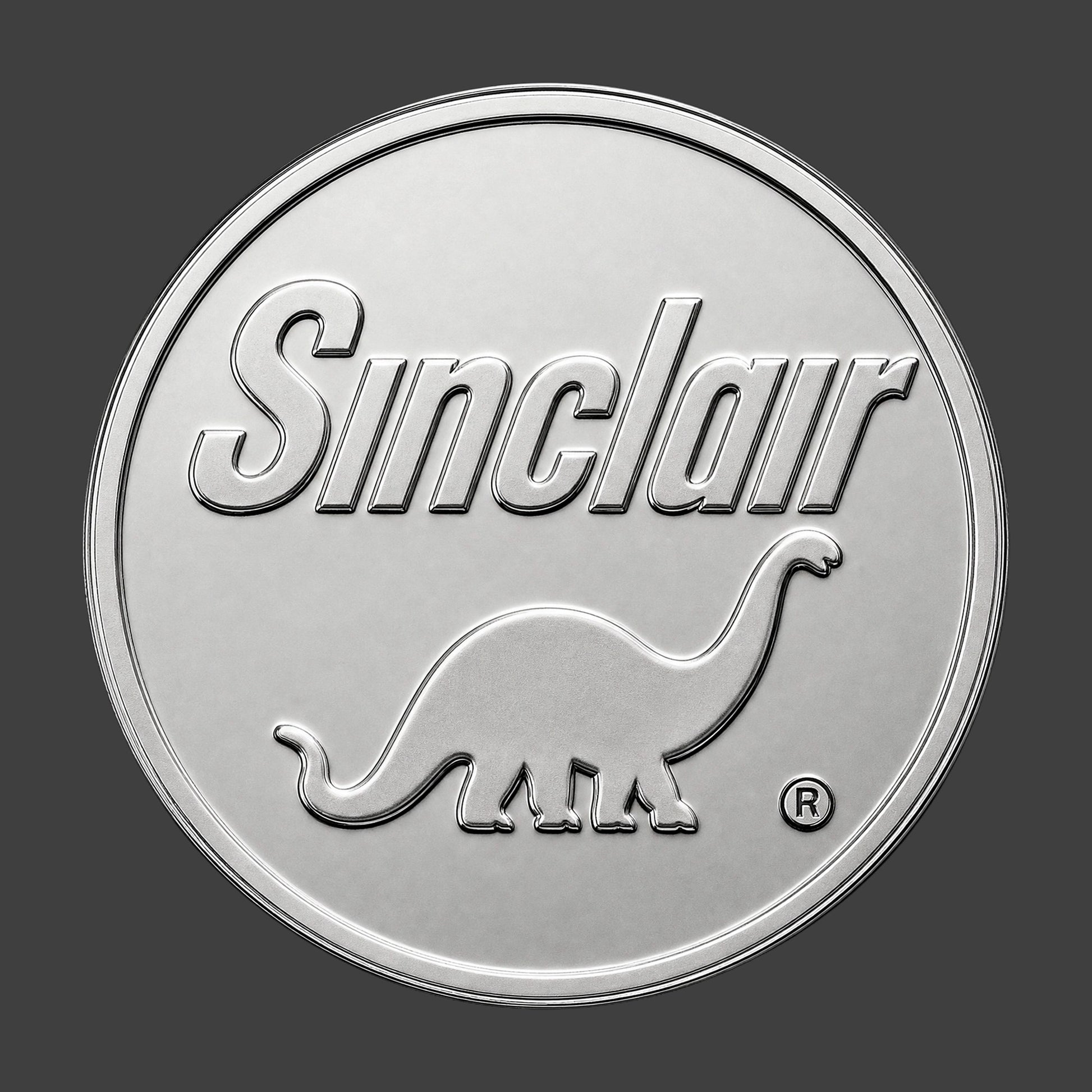 A silver finished, resin sculpted coin of a Sinclair logo