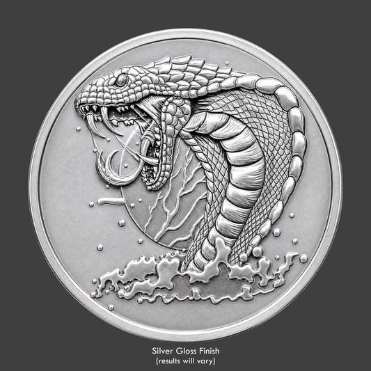A silver finished, resin sculpted coin of a vicious cobra snake